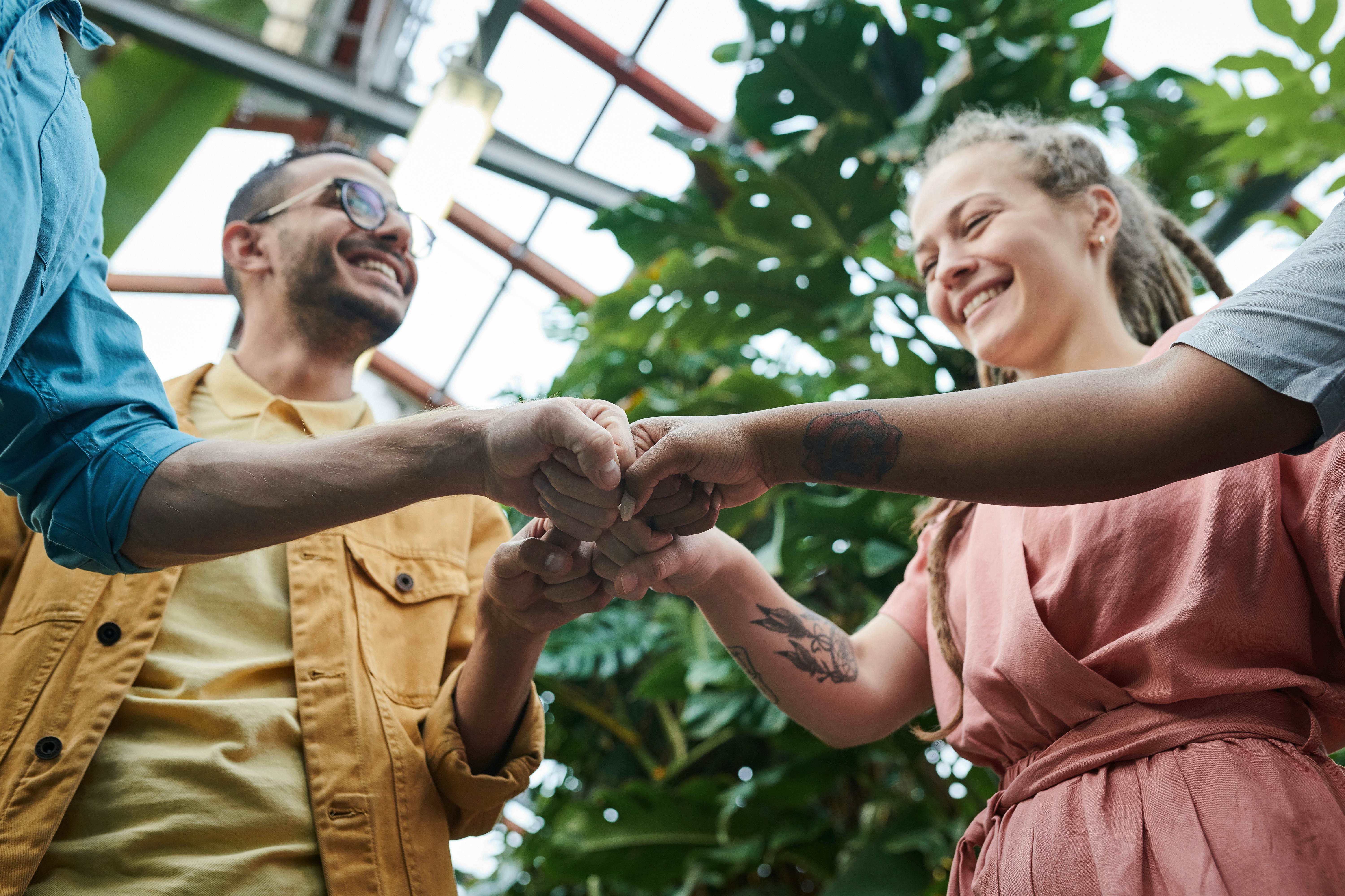 Team members joining hands together in unity